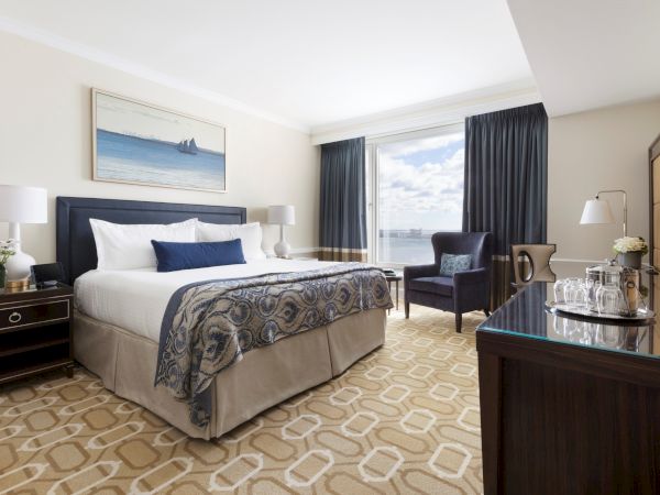 A well-appointed hotel room with a plush bed, elegant decor, and a view.