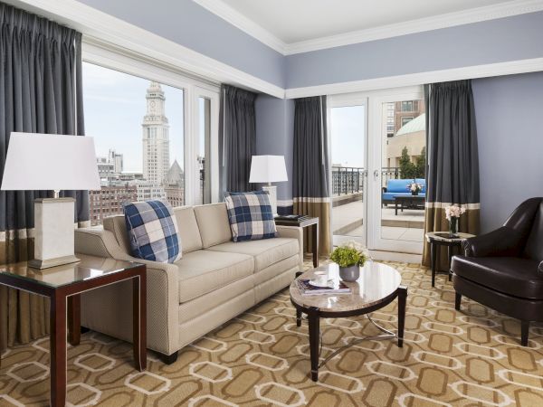 Elegant room with sofa, chairs, lamps, and city view.