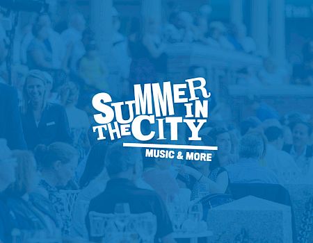 The image features a crowd at an outdoor event with text overlay "SUMMER IN THE CITY - MUSIC & MORE" in the center.