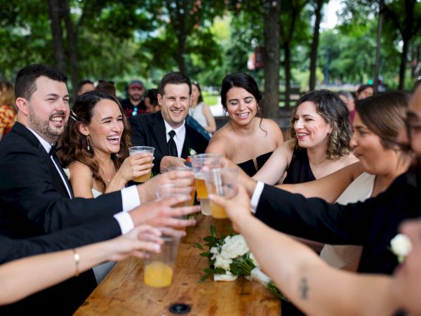 Wedding Party toasting glasses of beer at the beer garden